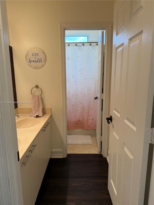 bathroom with vanity, wood finished floors, and a shower with shower curtain