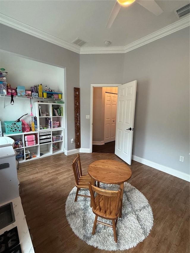 sitting room with baseboards, visible vents, wood finished floors, and ornamental molding