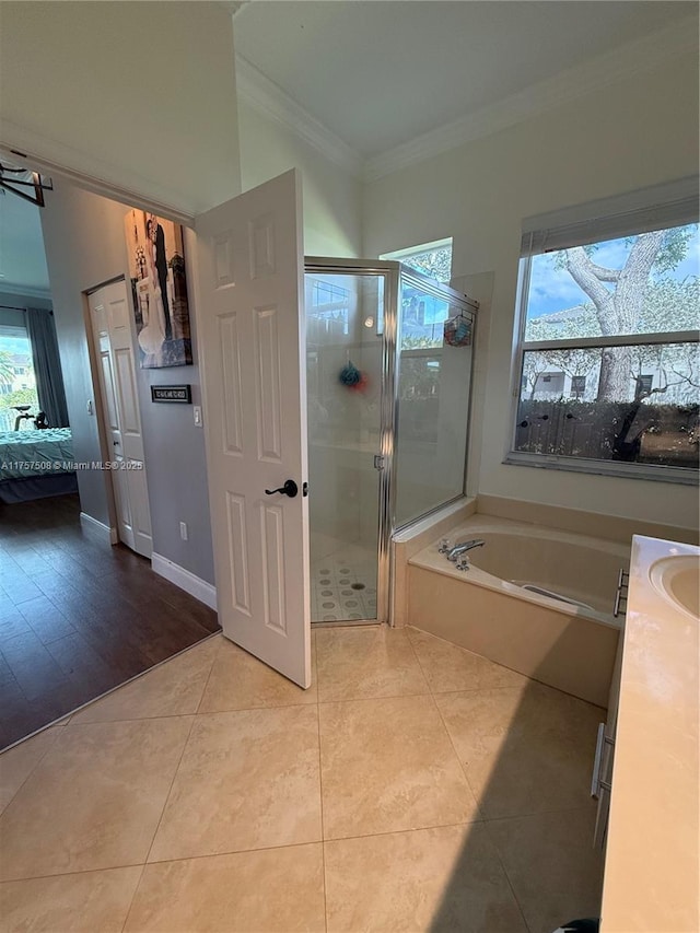 bathroom featuring a stall shower, connected bathroom, ornamental molding, tile patterned floors, and a garden tub