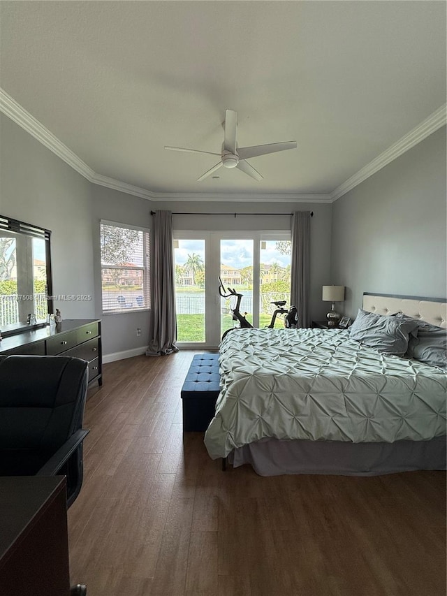 bedroom with access to outside, multiple windows, wood finished floors, and crown molding