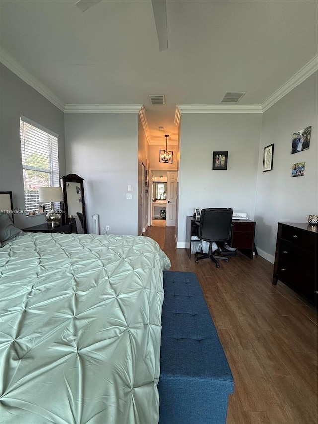 bedroom with ornamental molding, visible vents, and wood finished floors