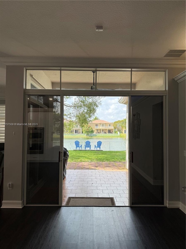 entryway featuring visible vents, dark wood finished floors, and a textured ceiling