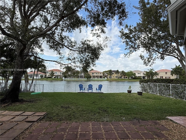 property view of water with fence private yard and a residential view