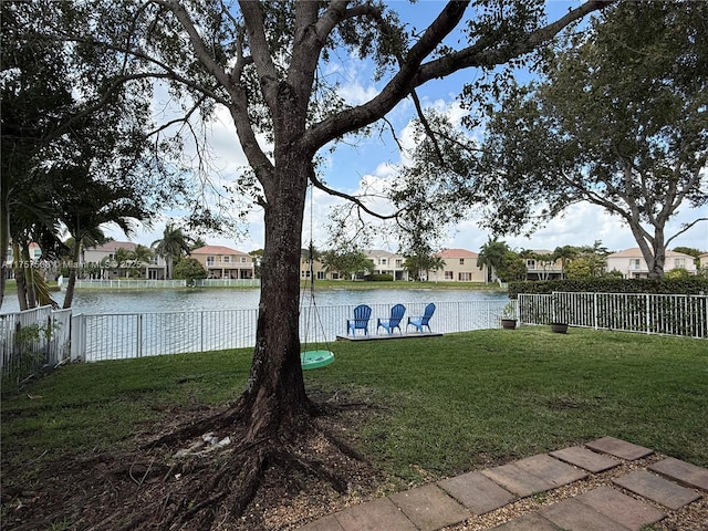 water view featuring a residential view and fence