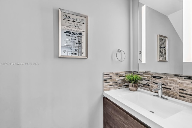 bathroom featuring vanity and decorative backsplash