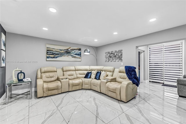 living room featuring recessed lighting and marble finish floor