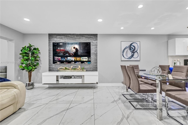 living area featuring recessed lighting, marble finish floor, and baseboards