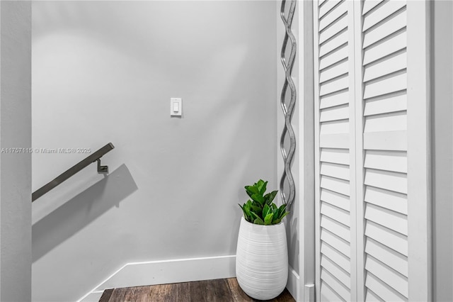 stairway with baseboards and wood finished floors