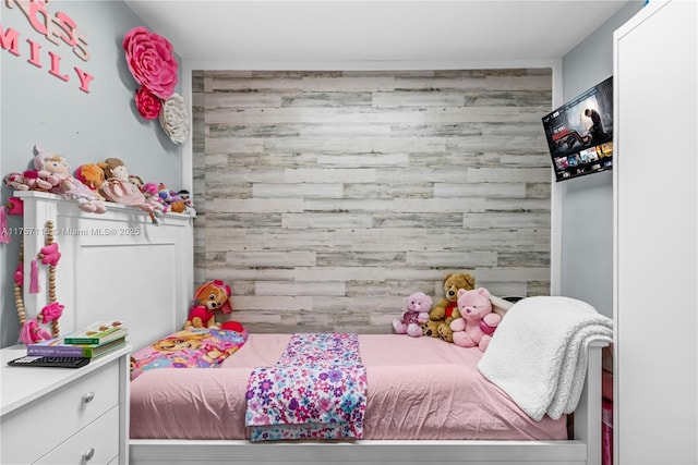 bedroom with wood walls