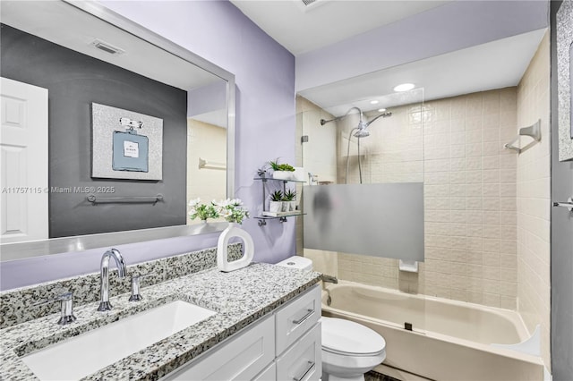 bathroom with toilet, visible vents,  shower combination, and vanity