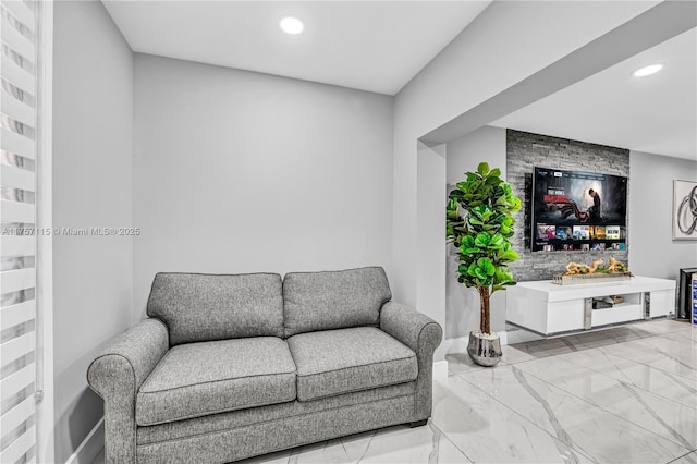 living area with marble finish floor, baseboards, and recessed lighting