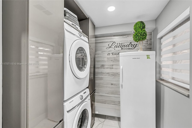 laundry room with stacked washer / dryer, laundry area, marble finish floor, and recessed lighting