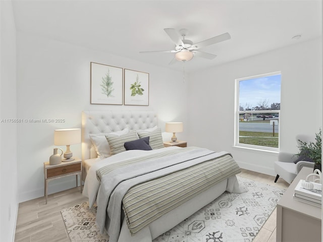 bedroom with light wood-style floors, baseboards, and a ceiling fan