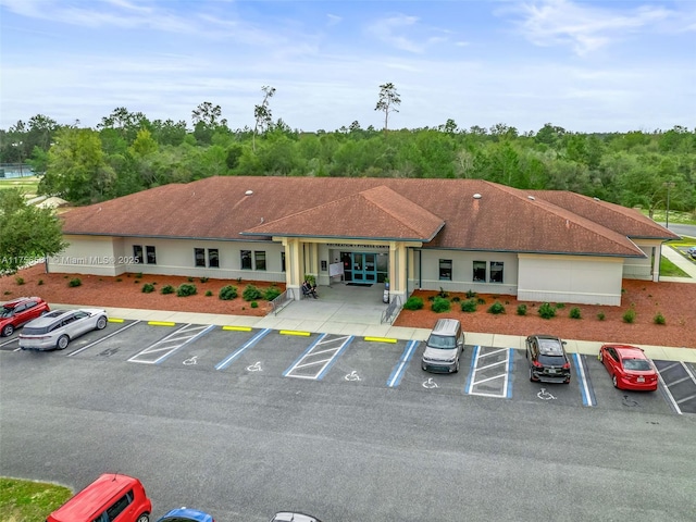 view of building exterior featuring uncovered parking