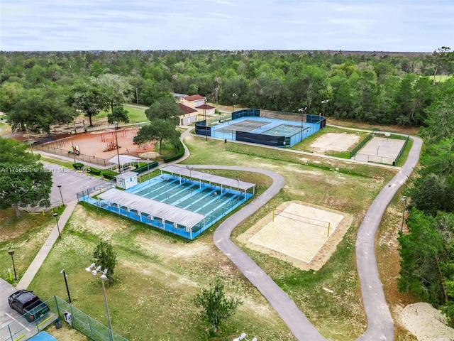 drone / aerial view featuring a wooded view