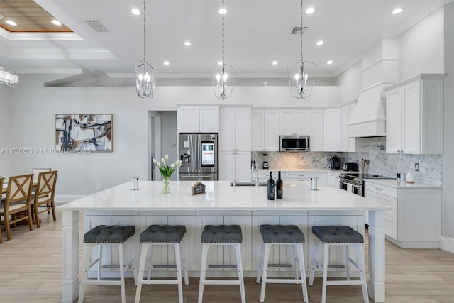 kitchen featuring white cabinetry, tasteful backsplash, appliances with stainless steel finishes, and ornamental molding