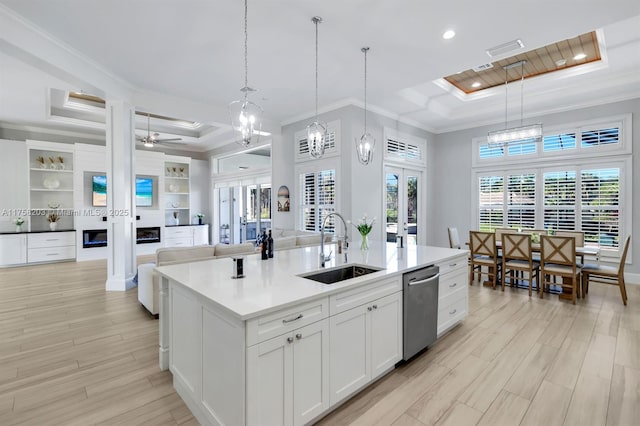 kitchen with stainless steel dishwasher, a raised ceiling, a sink, and french doors