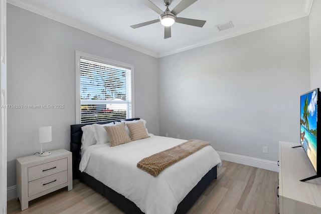 bedroom with baseboards, visible vents, light wood-style flooring, and crown molding