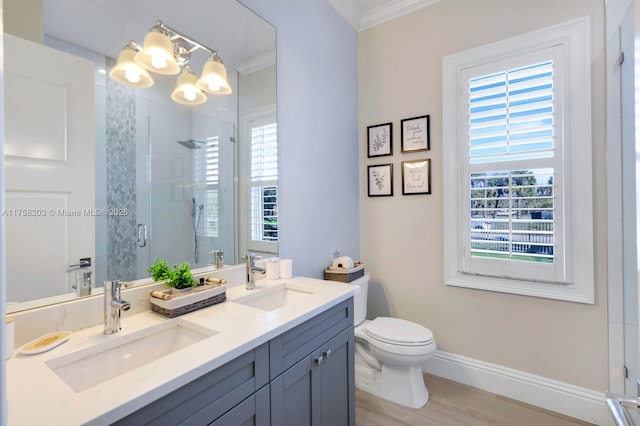 full bath with ornamental molding, a stall shower, a sink, and baseboards