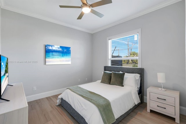 bedroom featuring baseboards, ceiling fan, wood finished floors, and crown molding