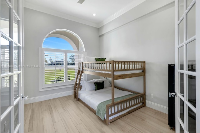 bedroom featuring baseboards, wood finished floors, crown molding, french doors, and recessed lighting