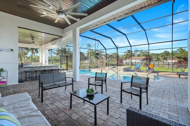 view of patio / terrace with outdoor dry bar, glass enclosure, outdoor lounge area, and a pool with connected hot tub