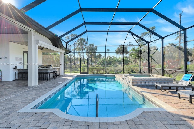 view of swimming pool with glass enclosure, outdoor dry bar, and a patio