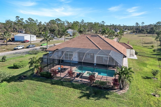 exterior space featuring a lanai, a patio area, fence, and a yard