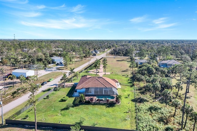 birds eye view of property with a forest view