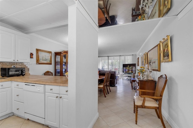 kitchen featuring a toaster, crown molding, light countertops, white cabinetry, and white dishwasher