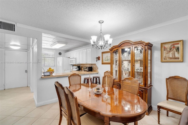 dining room featuring light tile patterned floors, visible vents, ornamental molding, a textured ceiling, and a chandelier