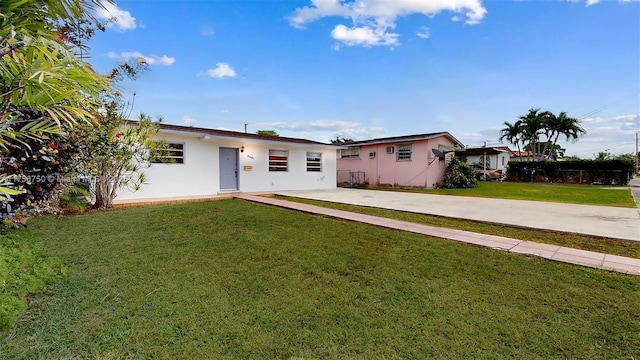 view of front of property with a front yard and stucco siding