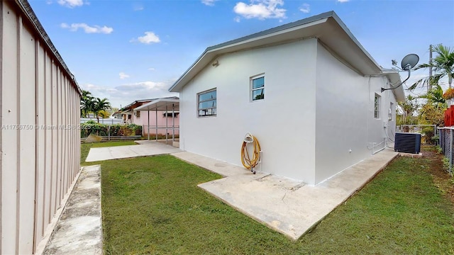 view of property exterior with a lawn, a patio, a fenced backyard, cooling unit, and stucco siding