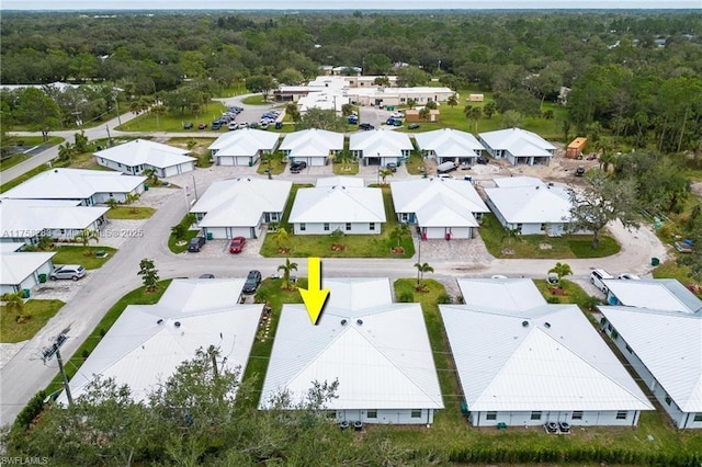 aerial view featuring a residential view and a view of trees