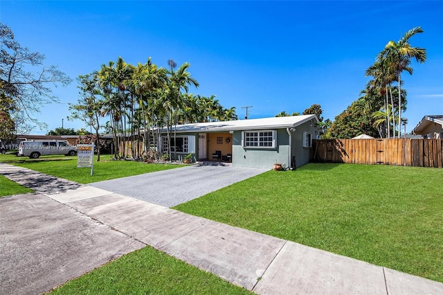 single story home with stucco siding, concrete driveway, a front lawn, and fence