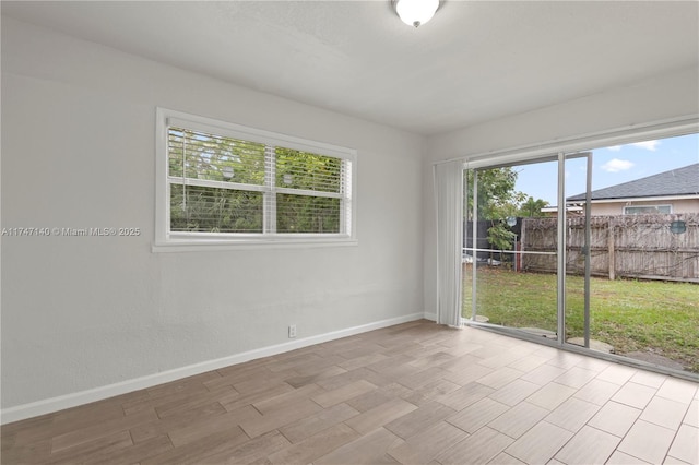 empty room featuring baseboards and wood finished floors