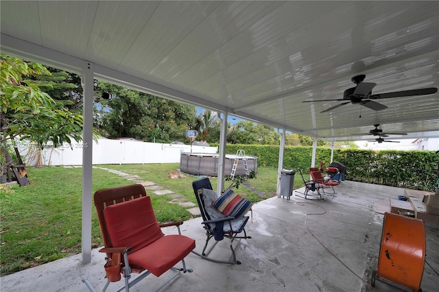 view of patio featuring a fenced backyard, a fenced in pool, and a ceiling fan