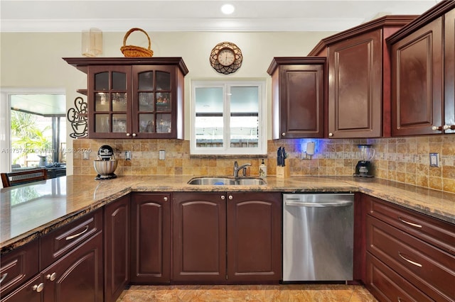 kitchen with light stone counters, crown molding, backsplash, stainless steel dishwasher, and a sink