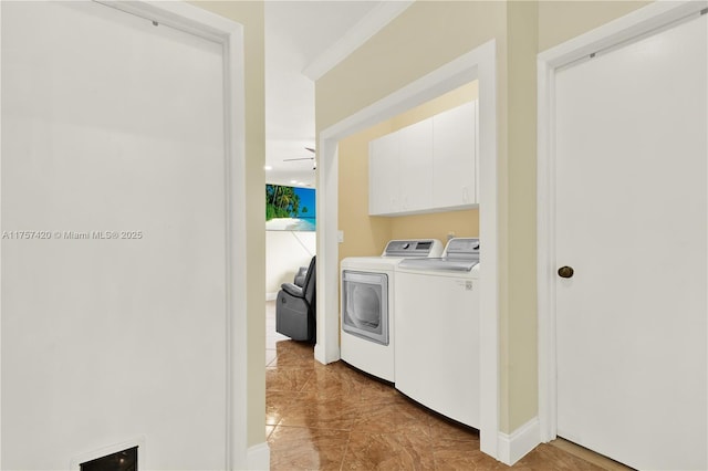 laundry area with baseboards, cabinet space, and washing machine and clothes dryer