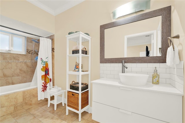 bathroom featuring tile patterned flooring, tiled shower / bath, crown molding, vanity, and backsplash