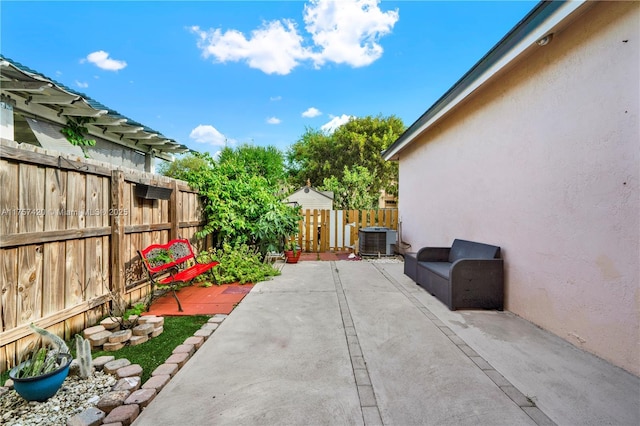 view of patio with cooling unit and fence