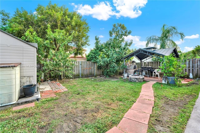 view of yard featuring a gazebo, a patio area, and a fenced backyard