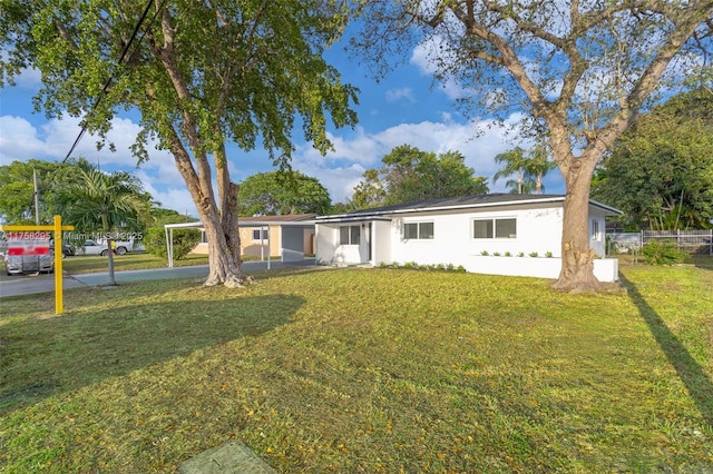 ranch-style house with a front yard and stucco siding