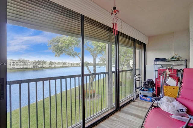 sunroom / solarium with a water view