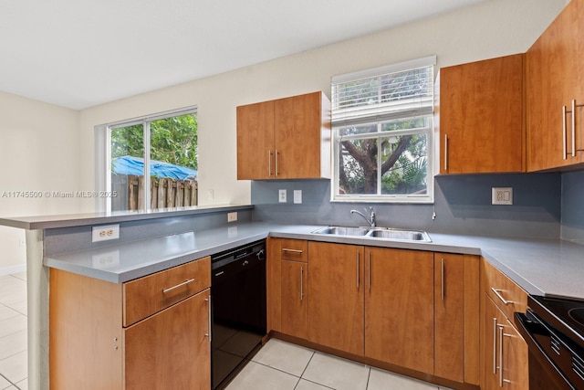 kitchen featuring brown cabinets, dishwasher, a peninsula, and a sink