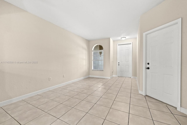 unfurnished room featuring baseboards