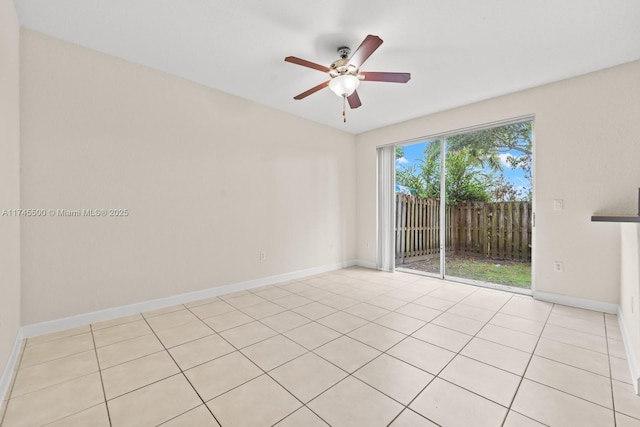 empty room featuring ceiling fan and baseboards