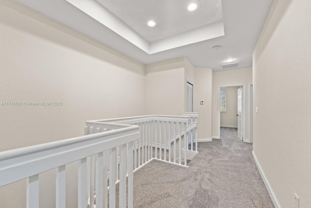 corridor featuring recessed lighting, carpet flooring, visible vents, an upstairs landing, and baseboards