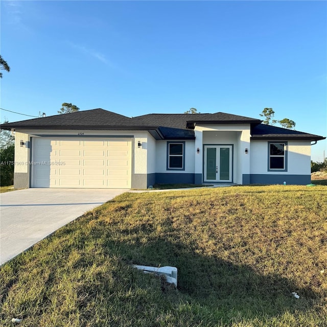 view of front of property with an attached garage, stucco siding, concrete driveway, and french doors