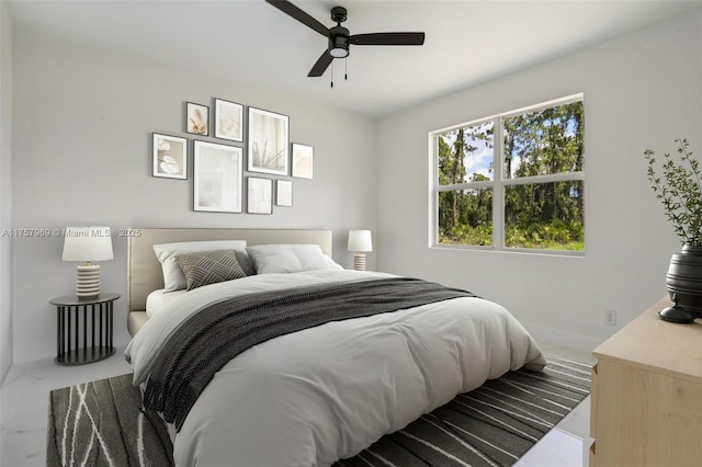 bedroom with baseboards and a ceiling fan